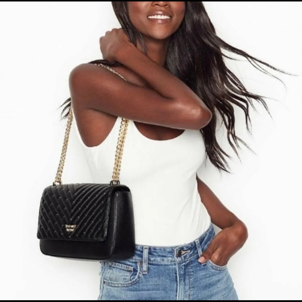 Victoria Secret black handbag with gold chain strap.